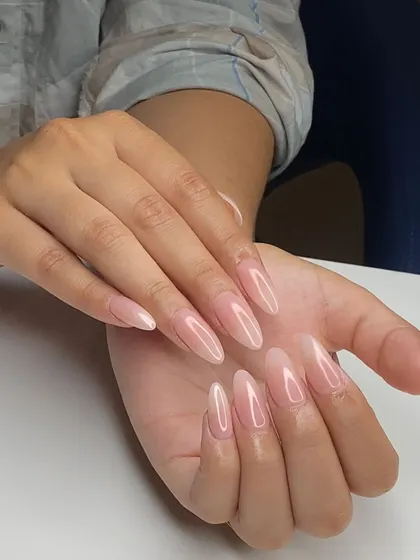 A flawless set of natural-looking, nude almond-shaped extensions. This student's work demonstrates perfect shaping and a clean, professional finish.