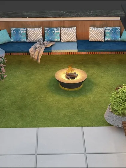 A top-down view of a cozy sunken seating area with a fire pit, part of the Bhiwani terrace design.