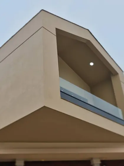 This bungalow's design was inspired by the iconic VitraHaus. We adapted the concept to create a unique residential form with stacked volumes and a distinctive, angular balcony space.