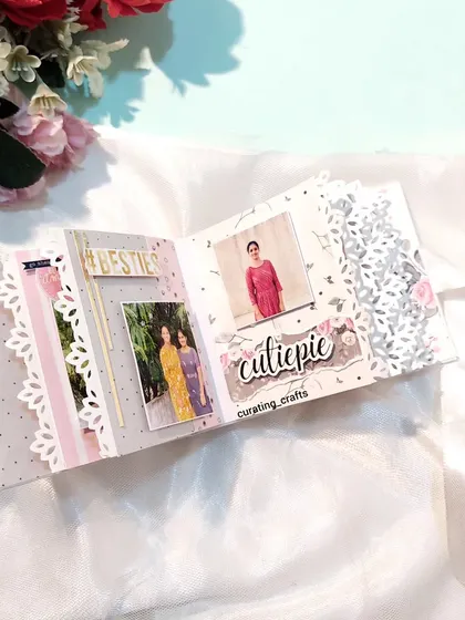 An inside page of the mini scrapbook, with delicate lace-cut edges.