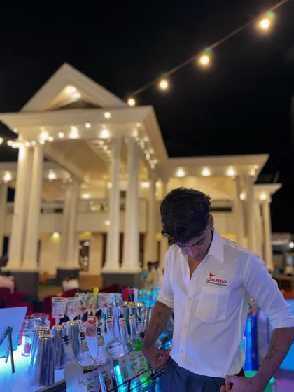 A candid shot of our bartender at work, capturing the authentic atmosphere of a large event.
