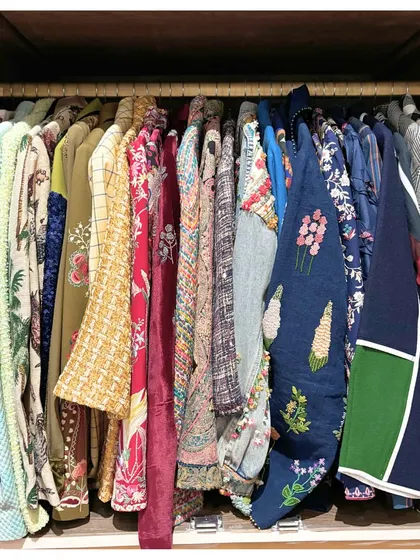 Here's some inspiration to organize your closets before the new year. This wardrobe showcases a collection of beautiful jackets and tops, all hung neatly to be visible and ready to wear.