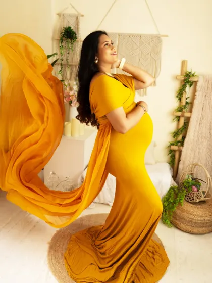 A beautiful side profile in a yellow gown, with the fabric tossed to create a wave of color and movement.