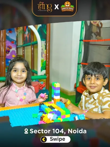 Two children building together with colorful blocks in the toddler section. This area encourages creativity and fine motor skill development.