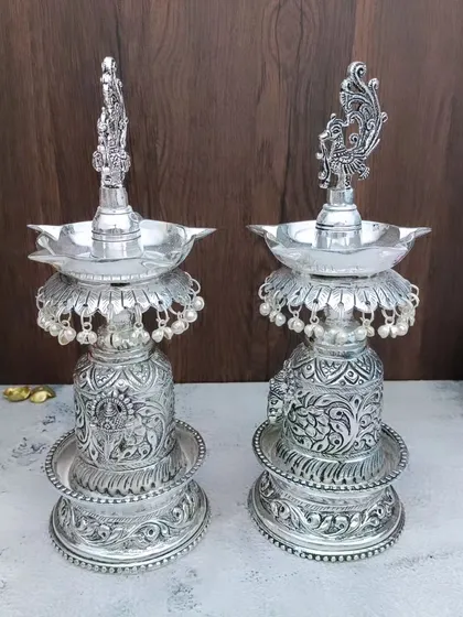 A different angle of the antique Hamsa designer vilakku, showing the detailed carving on the base and the elegant form of the sacred swan.