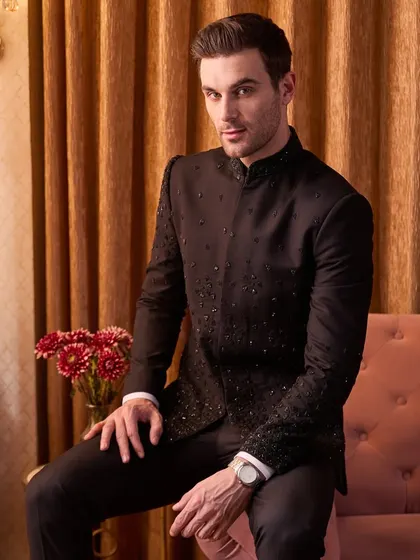 A portrait of modern royalty. The black bandhgala, with its restrained yet classy embroidery, is the perfect choice for a formal reception or sangeet. The fit is tailored to be sharp yet comfortable, allowing you to own the evening.