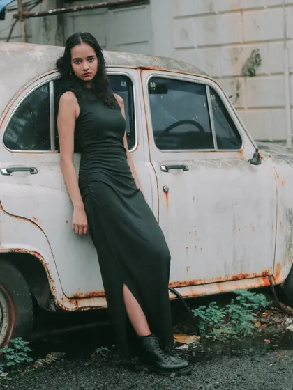 Leaning against a vintage car, this portrait has a classic, almost rebellious feel. It's about capturing an attitude, not just a picture.
