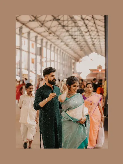 A candid shot of a couple walking through a temple, capturing the natural flow of the day.