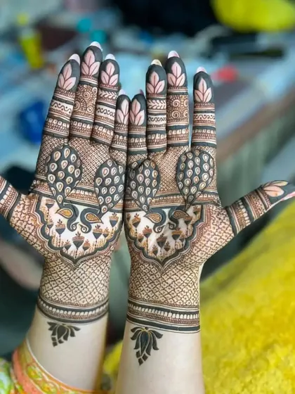 A unique take on the peacock motif, where the body of the peacock is filled with intricate details. The symmetry on both hands is perfect.