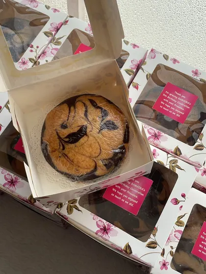 Eggless marble tea cakes packed as return gifts for a birthday party. The floral boxes and custom 'thank you' stickers add a personal touch.