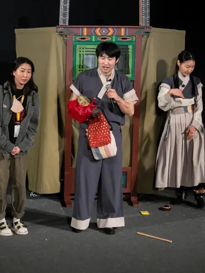 The performers of 'Hong Dongji & Isimi' explain their craft to the audience after the show, sharing insights into Korean traditional puppetry.