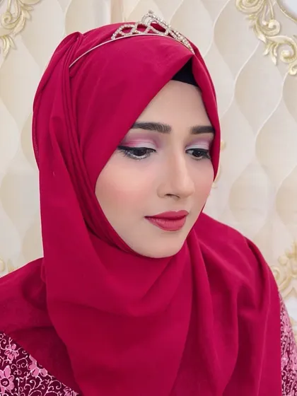 A close-up of the soft pink eye makeup on the client with the hijab.