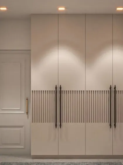 We added visual interest to this simple white wardrobe by incorporating a central band of vertical fluting and classic handles. This detail elevates the design from basic to bespoke.
