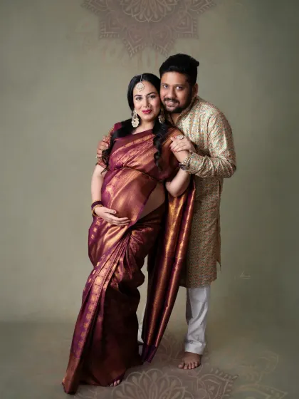 A loving couple's portrait. The way they are posed together, both dressed in traditional wear, shows their strong bond and shared excitement.