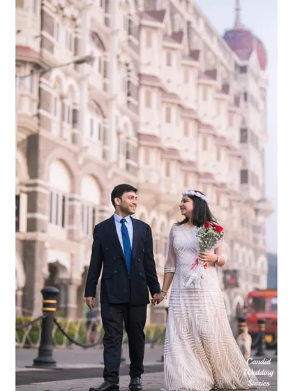 A classic, elegant walk hand-in-hand, with Mumbai's iconic Taj Mahal Palace Hotel providing a majestic backdrop. This style of pre-wedding photography focuses on creating timeless, sophisticated portraits.