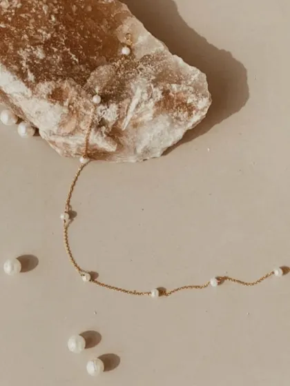 My freshwater pearl choker, laid out with loose pearls. This piece is handmade to help soothe the mind and calm anger.