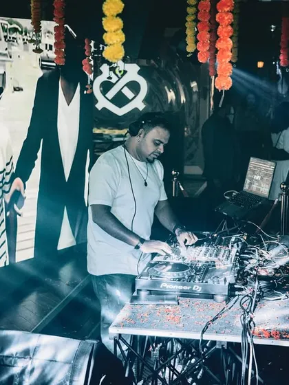 Mixing tracks with the VJ screen showing visuals in the background. This shot captures both the audio and visual elements of my performance.