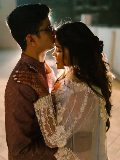 An intimate and romantic moment between the couple. The bride's makeup is flawless, even in this close-up shot.