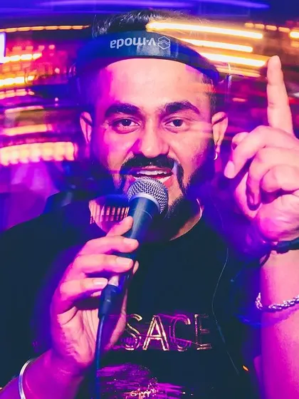On the mic, pointing to the crowd. This is my signature move, making everyone feel seen.