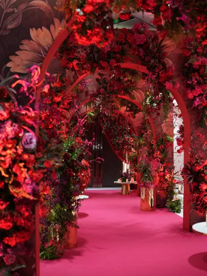 Who says an entrance can't be the main event? I designed this immersive floral tunnel with cascading arches of deep red blooms, creating a dramatic and passionate pathway for guests. It’s about building anticipation and making the first step into a celebration an unforgettable experience in itself.