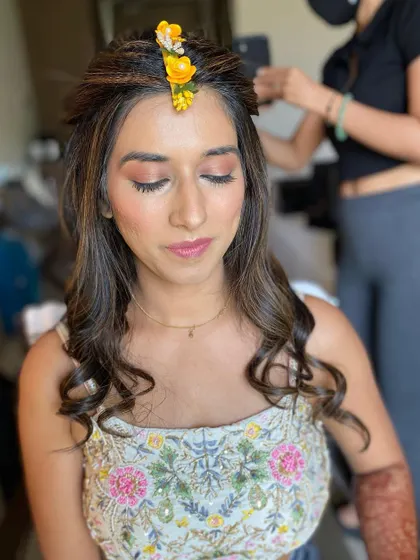 A close-up of the eye makeup for the Haldi ceremony, featuring soft peach and brown tones.