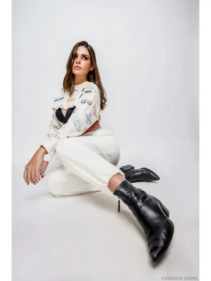 Style that speaks volumes. A full-length studio shot showcasing a casual, edgy fashion look against a clean white background.