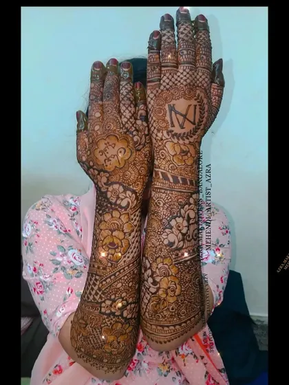 This bridal mehendi features personalized initials within a floral design, adding a special touch for the bride.