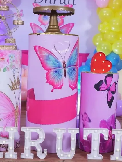 A close-up of the custom-printed pedestals for the butterfly theme party. The vibrant colors and sharp graphics really make the setup stand out.