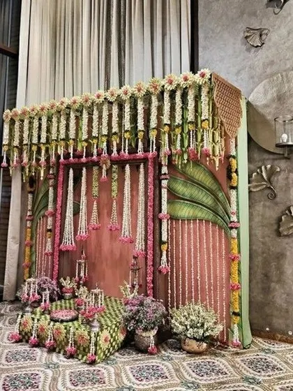 A beautiful and intimate setup for a traditional ceremony, with hanging floral strings and antique-style decor.