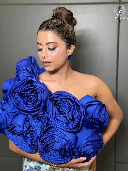 This shot highlights the flawless glass skin and the intricate details of the blue rose top. A truly unforgettable glow.