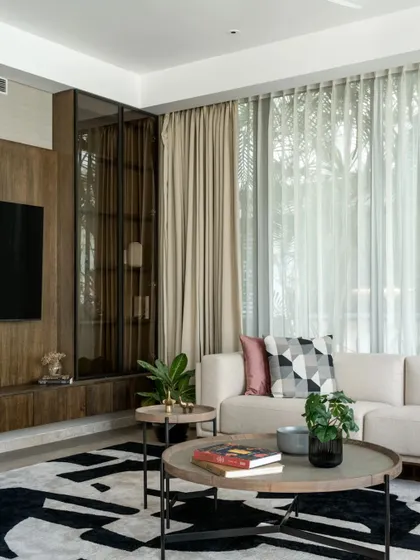 The media unit in the living room combines warm wood with smoked glass, providing elegant storage that feels integrated with the architecture. This piece balances functionality with a refined aesthetic, keeping the focus on the room's overall sense of harmony.