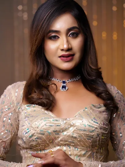 This portrait highlights the balance between the sparkling outfit and the elegant makeup. The look is glamorous without being overpowering.