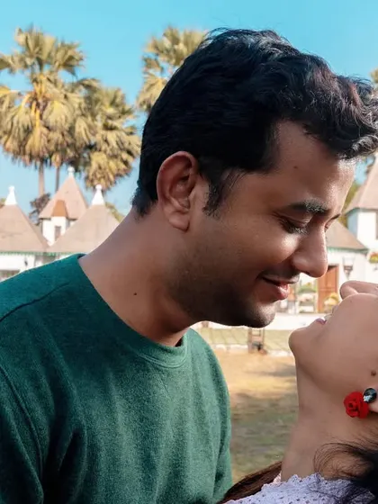 A beautiful close-up capturing a look of pure adoration. They are lost in their own world, smiling at each other, showcasing the simple happiness they find in just being together.