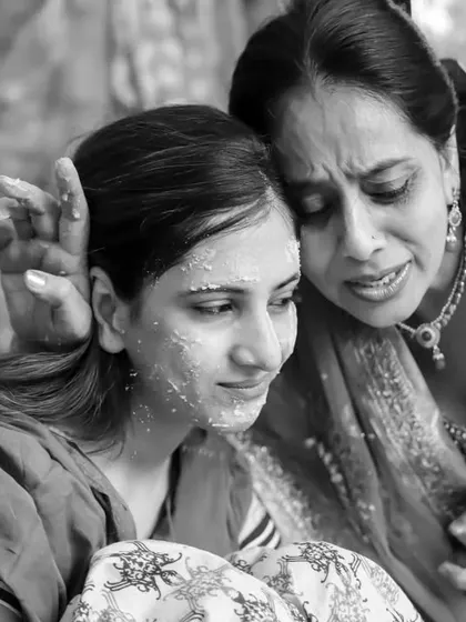A powerful black and white photo capturing an emotional moment between a mother and daughter during the Haldi. This is the kind of raw, unforgettable memory I aim to preserve.