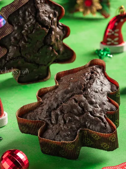 Christmas-themed tree-shaped chocolate cakes on a festive green background, perfect for holiday marketing.