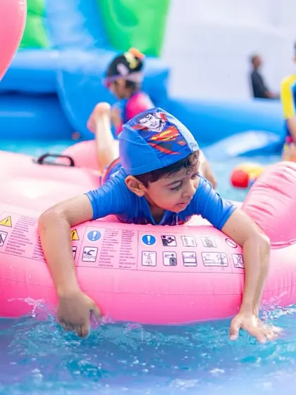 A flamingo float adds a splash of color and fun to this kids' pool party.