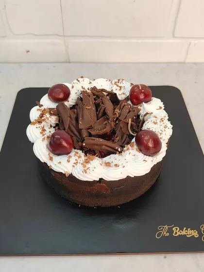 A classic Black Forest cake, one of the many I made in January. It's decorated with fresh whipped cream, chocolate shavings, and cherries.