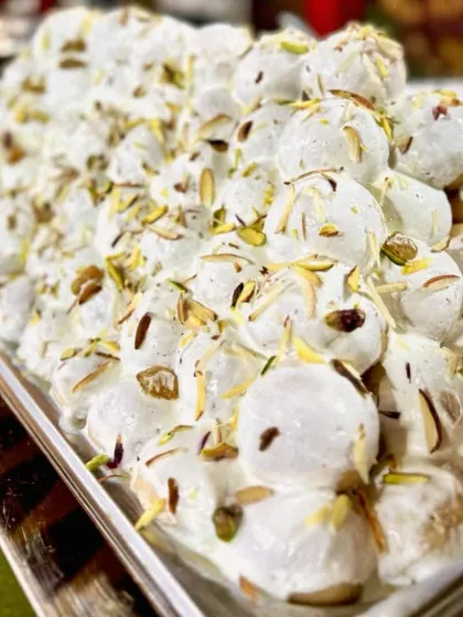 A close-up of my Dahi Bhalla, showcasing the creamy texture and the garnish of slivered almonds and pistachios. It's a refreshing and cooling chaat perfect for any season.