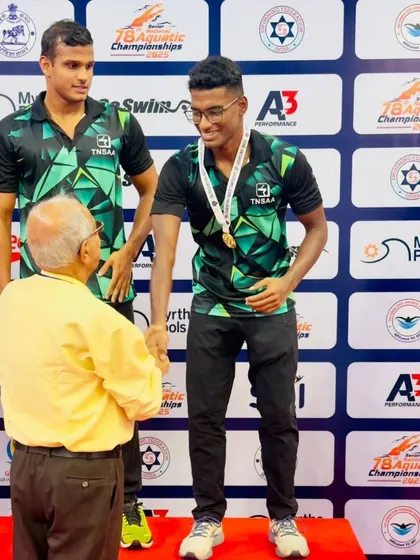 Nithik Nathella receiving his gold medal on the podium.