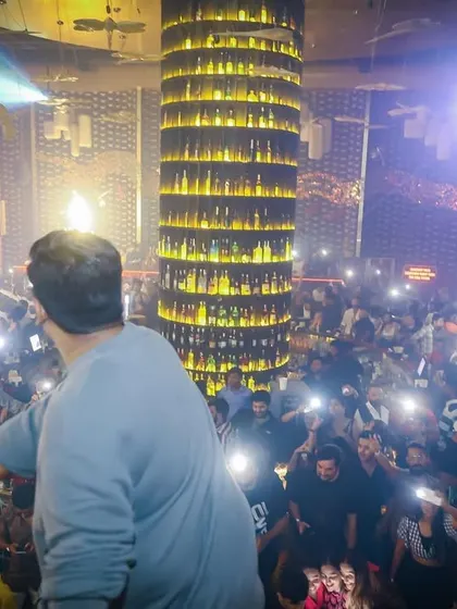 A sea of lights from the crowd's phones. This is a powerful moment when everyone in the club is connected, capturing a memory together.