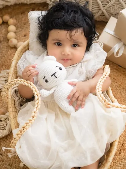 Cuddling with her knitted bunny toy. I have a wide range of props in my studio to add a personal and cute touch to your baby's photos.