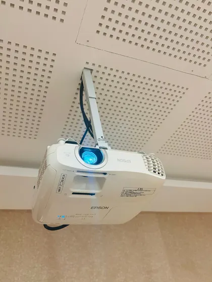 A close up of the ceiling mounted Epson home theater projector. I make sure all installations are clean and professional, with wiring neatly managed for a tidy look that doesn't distract from the experience.