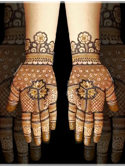 A beautiful design featuring a central lotus motif on the palm, surrounded by delicate patterns. The floral cuff on the wrist completes the look.