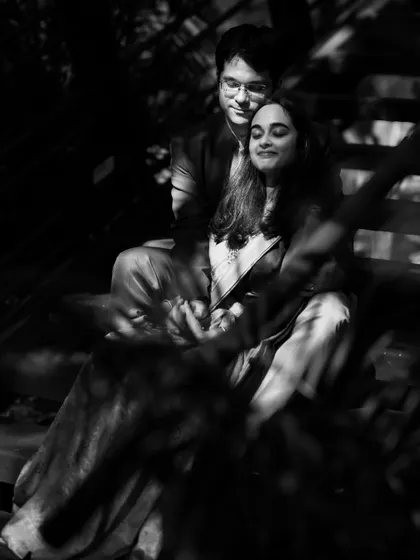 An artistic black and white photo using shadows and soft focus. This style creates a moody, romantic, and intimate portrait that feels like a stolen moment.