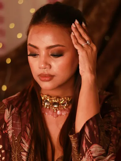 A close-up on the details of this editorial makeup look. The blended eyeshadow and glowing skin create a soft yet impactful style.