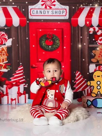 A little one enjoying a candy prop during our delightful and imaginative Candy Land photoshoot.