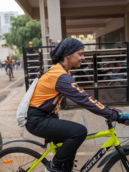 A focused cyclist pedals through the neighborhood during the Tour de Forest.