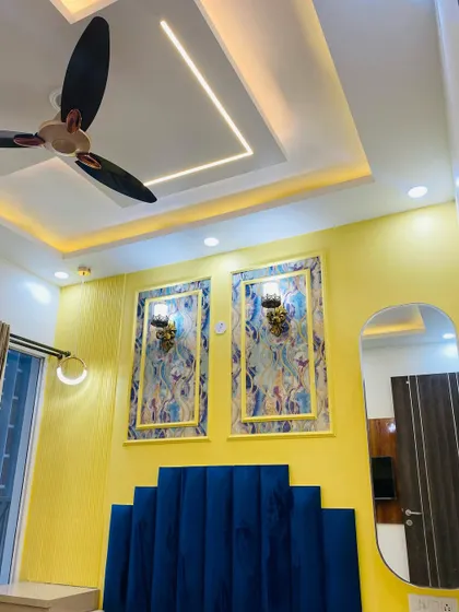 Another angle of the master bedroom, showing the false ceiling design with integrated profile lighting.