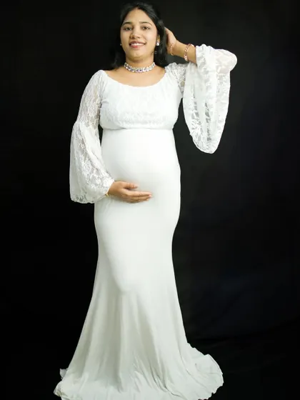 Another beautiful pose from the same solo session, showing how we can capture a variety of looks and moods. The mother-to-be gently touches her hair, looking serene and confident.