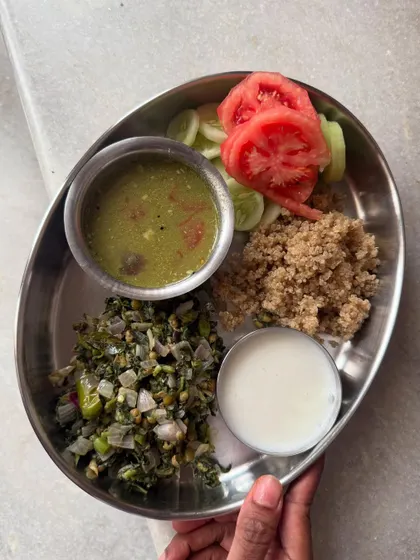 A simple, clean meal of bassaru palya (a lentil and greens dish) with quinoa, fresh salad, and yogurt, perfect for a light yet complete lunch.